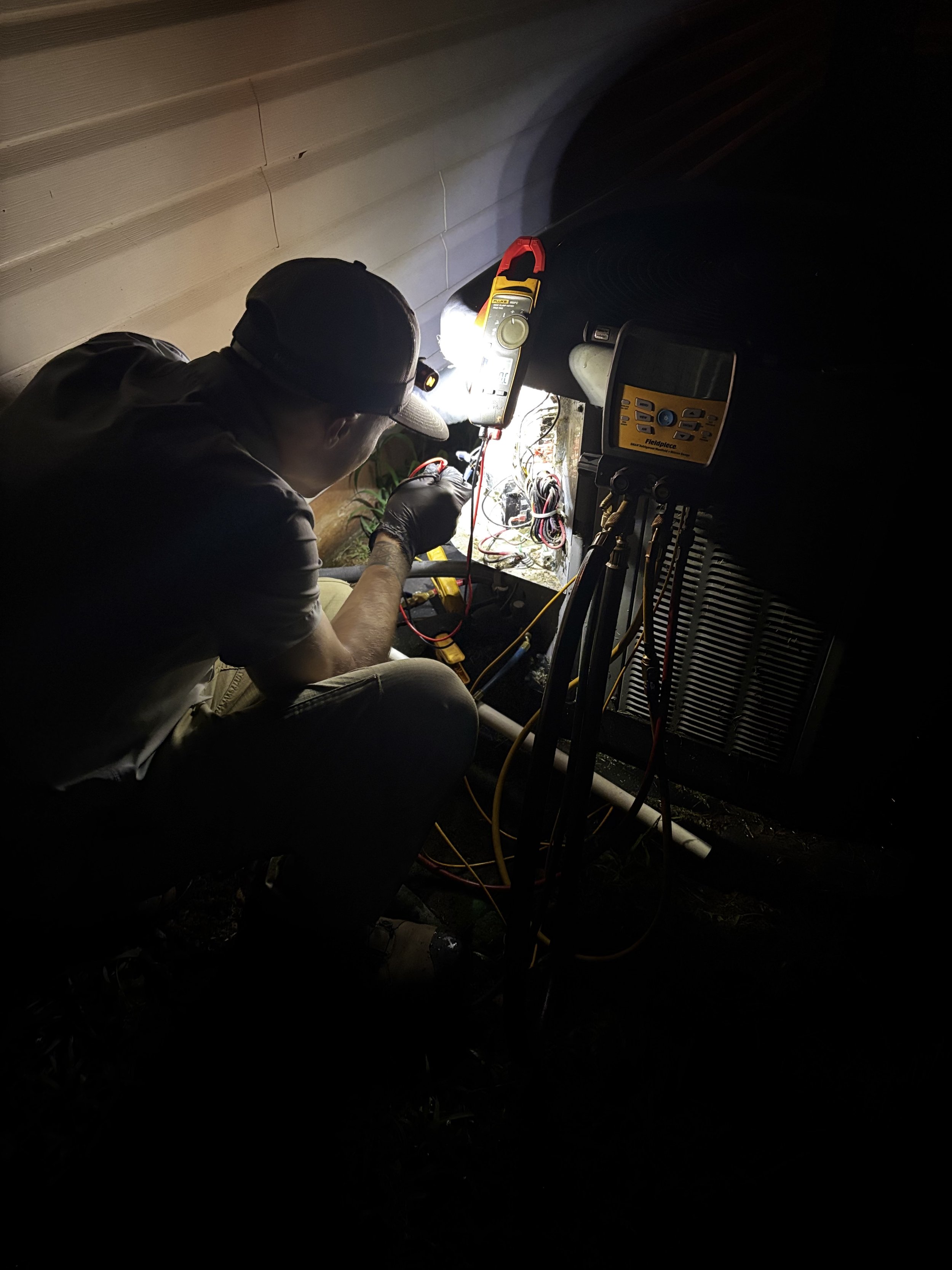 Tech doing HVAC repair service