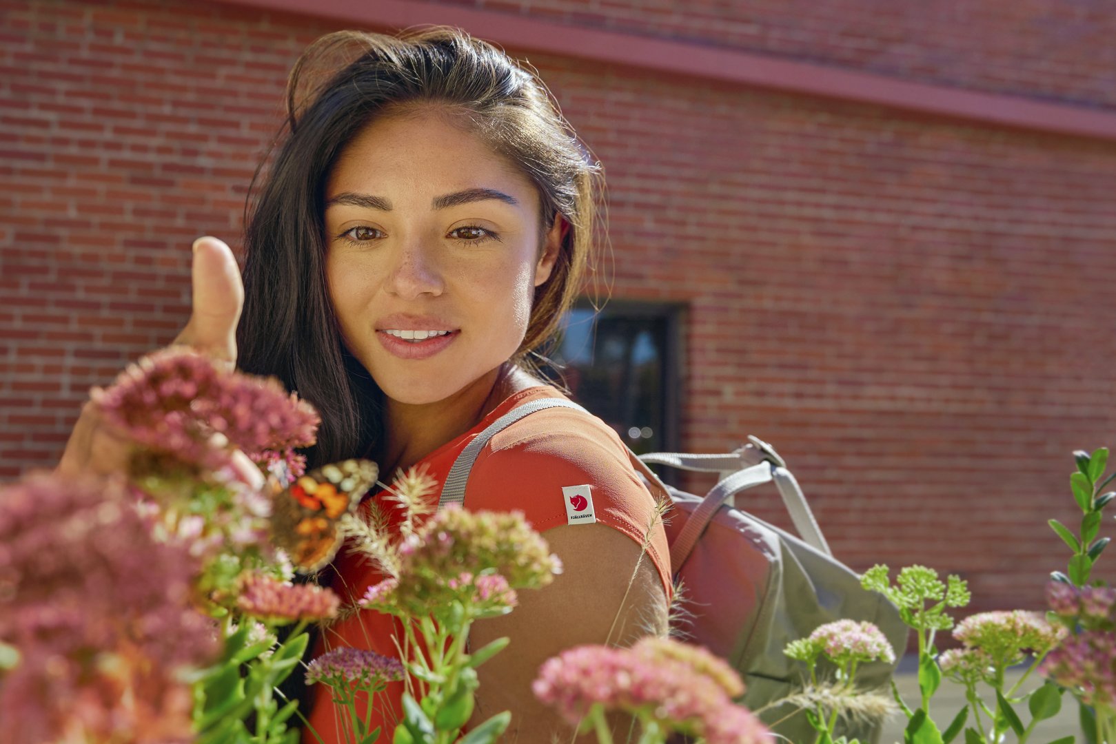 Women catches butterfly in Fjallraven High Coast Lite Dress Downton Bentonville, Arkansas.