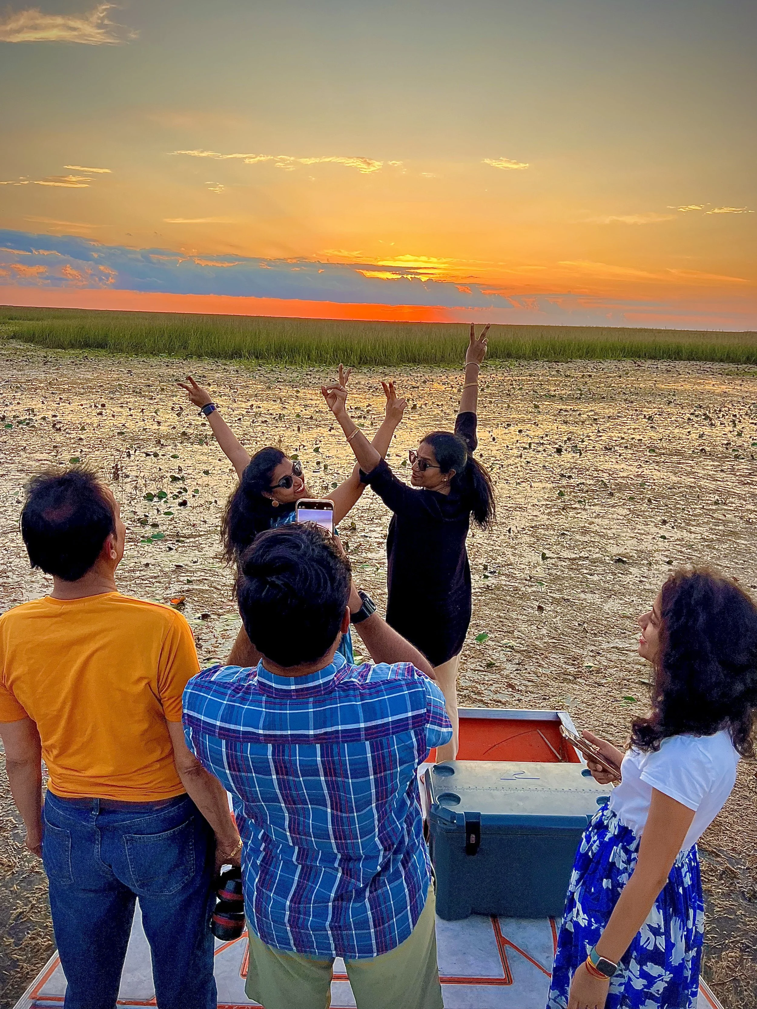 Group watching sunset over the Everglades from an airboat
