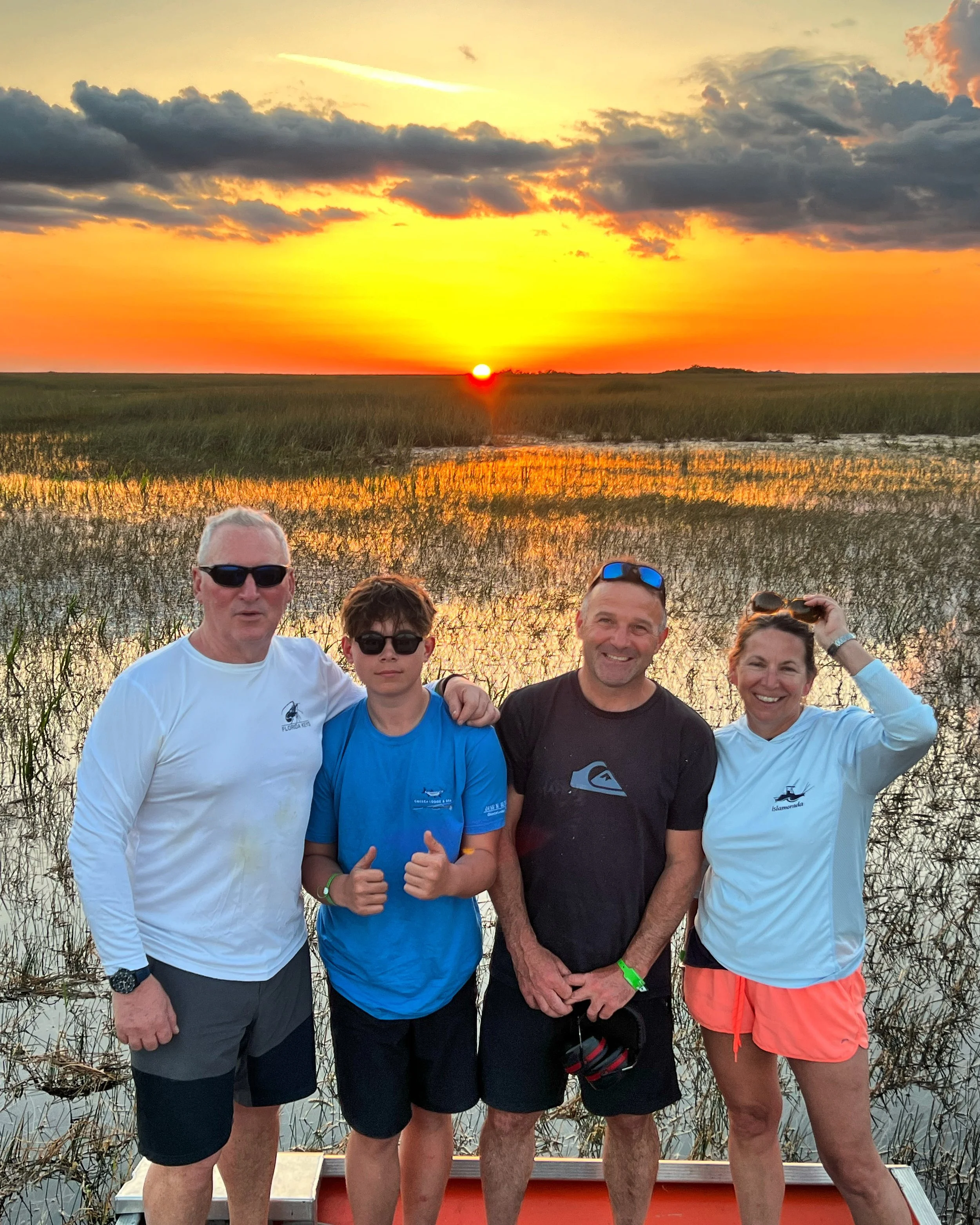 Guests aboard a private airboat at sunset in the Everglades