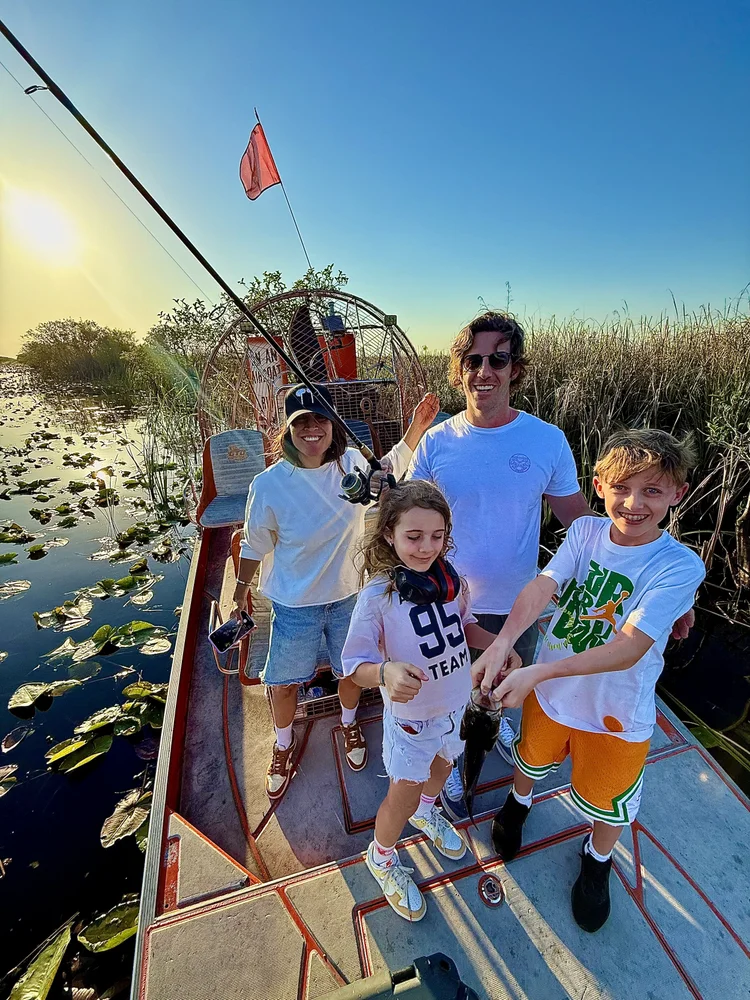 Family with a largemouth bass on an Everglades fishing trip
