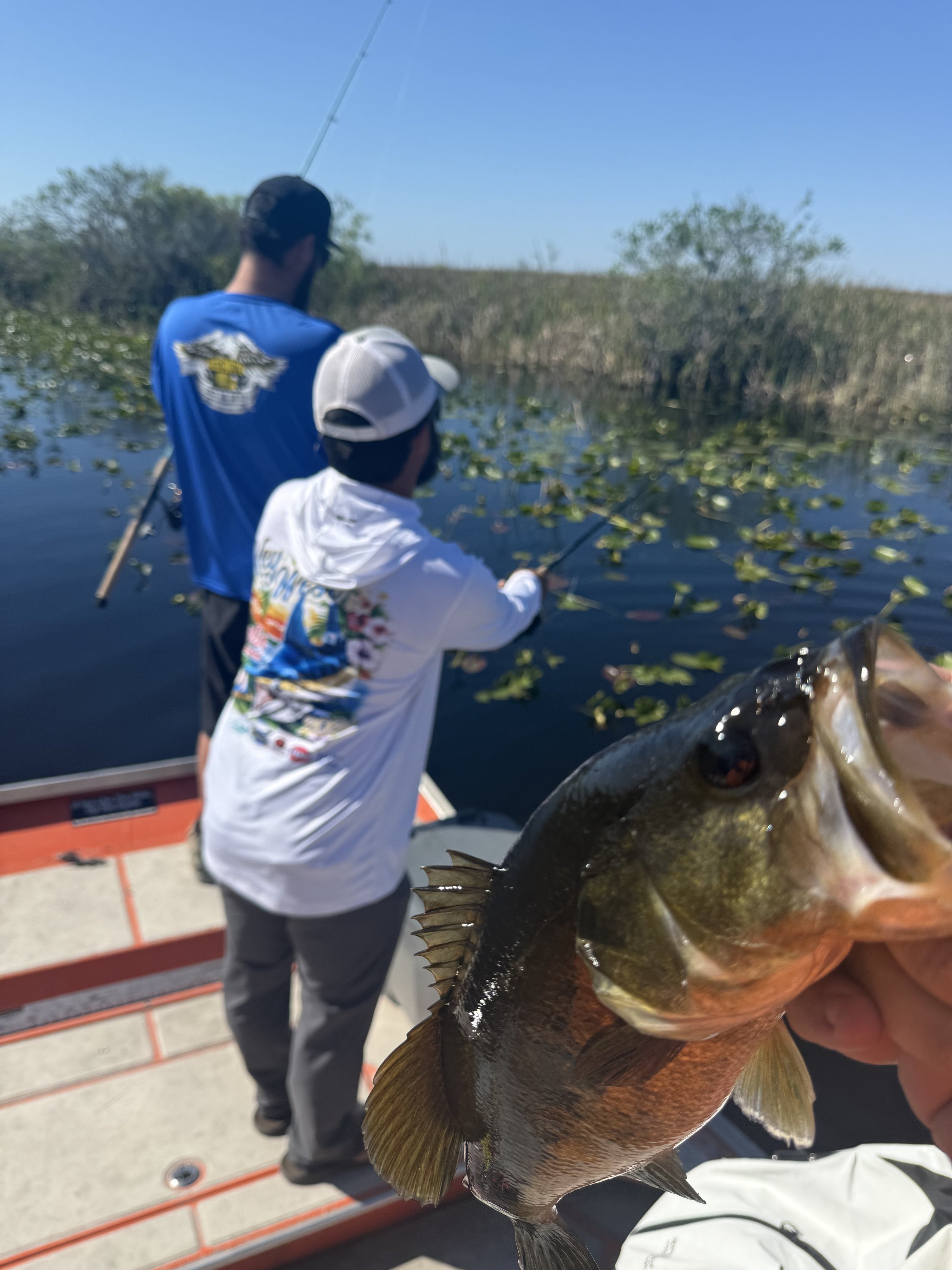 Two anglers displaying their catch aboard an Everglades airboat