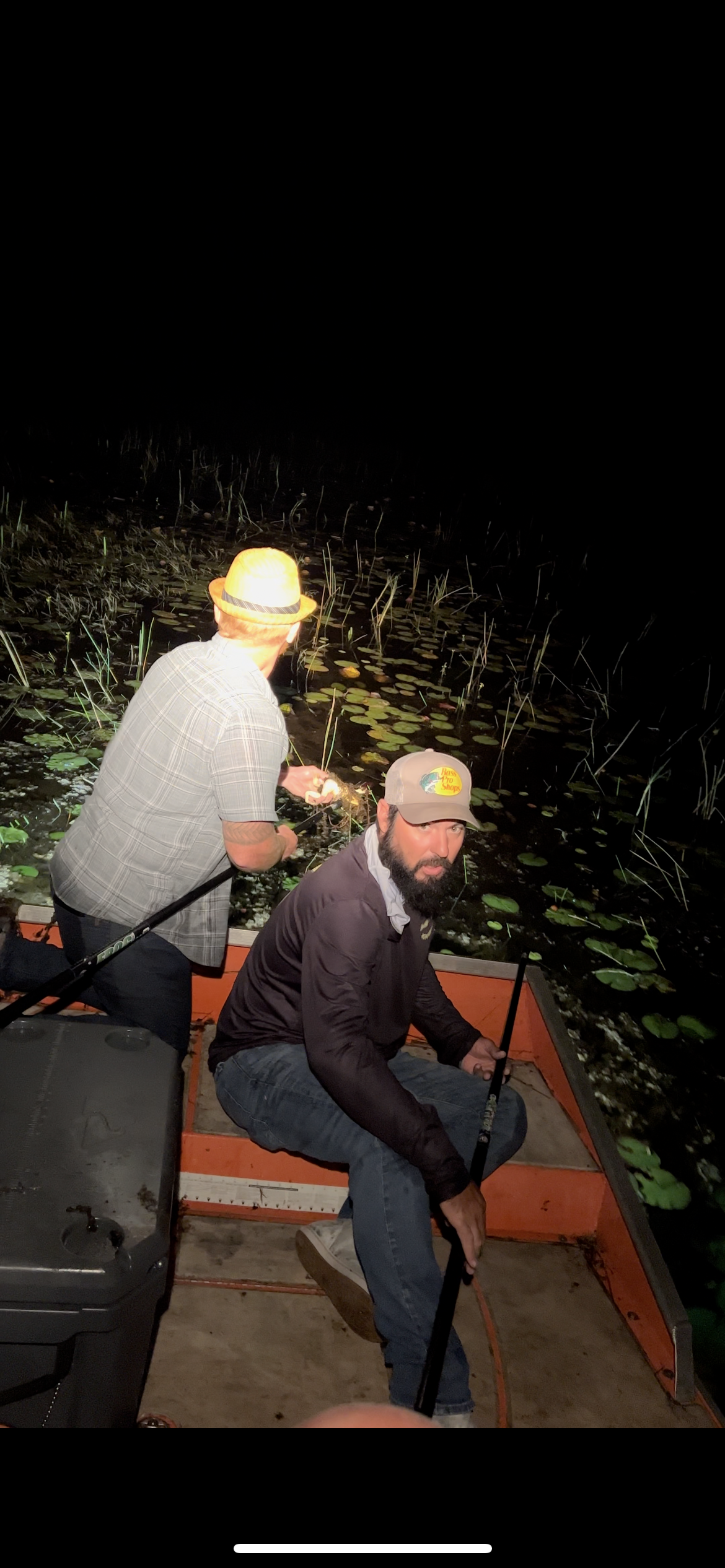 Guests with a frog gig and flashlight during a private Everglades night outing