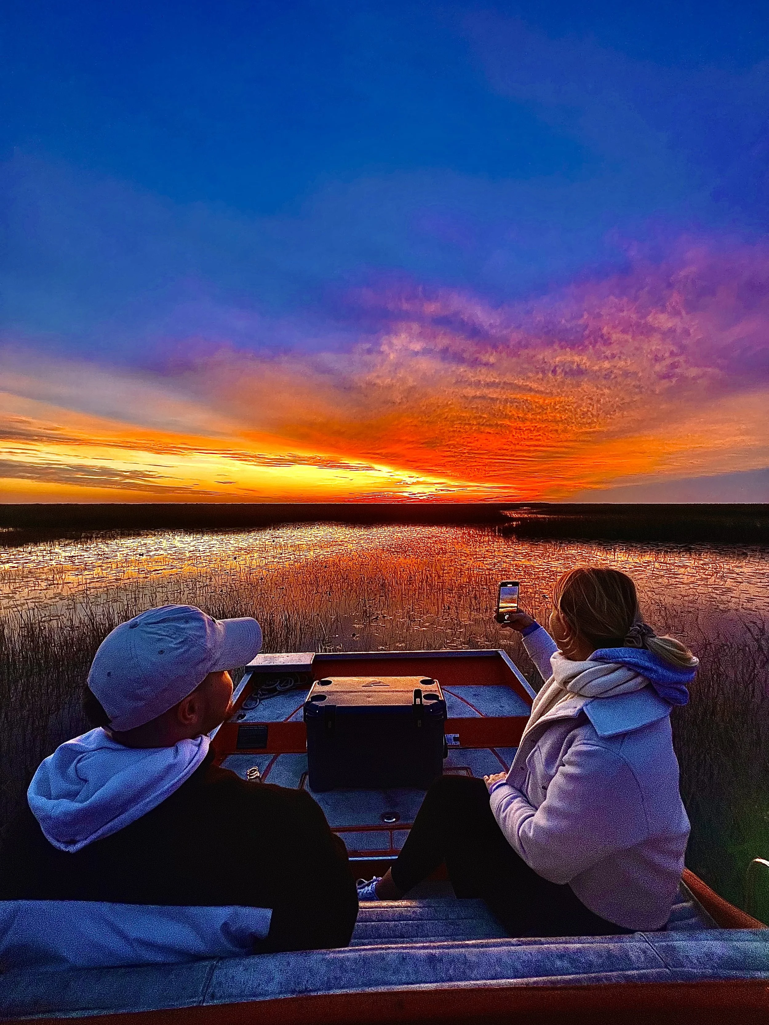 Two guests enjoying a private Everglades sunset airboat tour