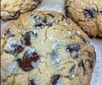 Close-up of chocolate chip cookies with chocolate chunks and sugar on top.