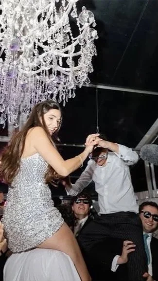 Bride and Groom enjoying their Wedding and dancing on guests shoulders.