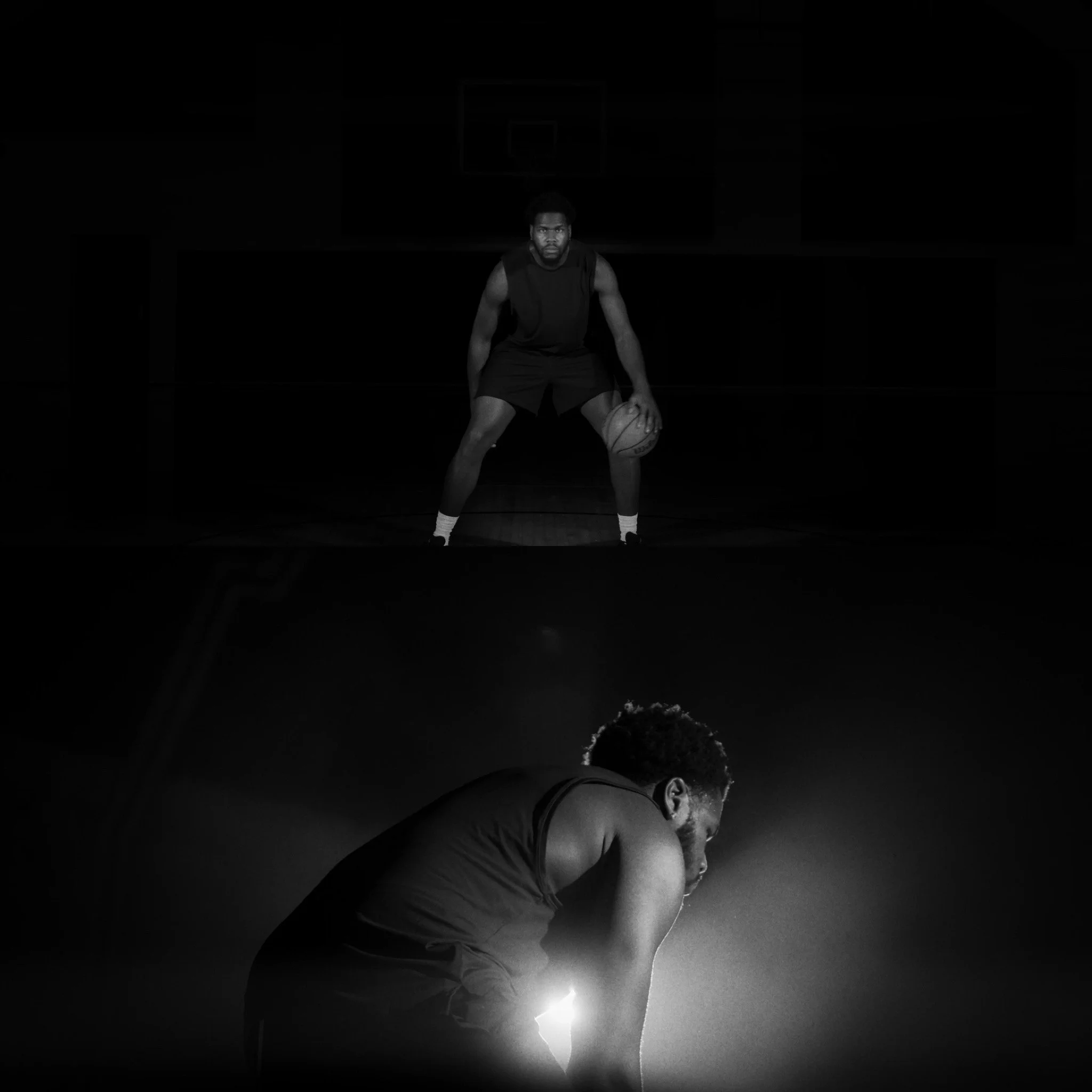 Black and white photo of two male basketball players, one standing on a court holding a basketball, the other crouched in a gym or studio setting, with a basketball hoop in the background.