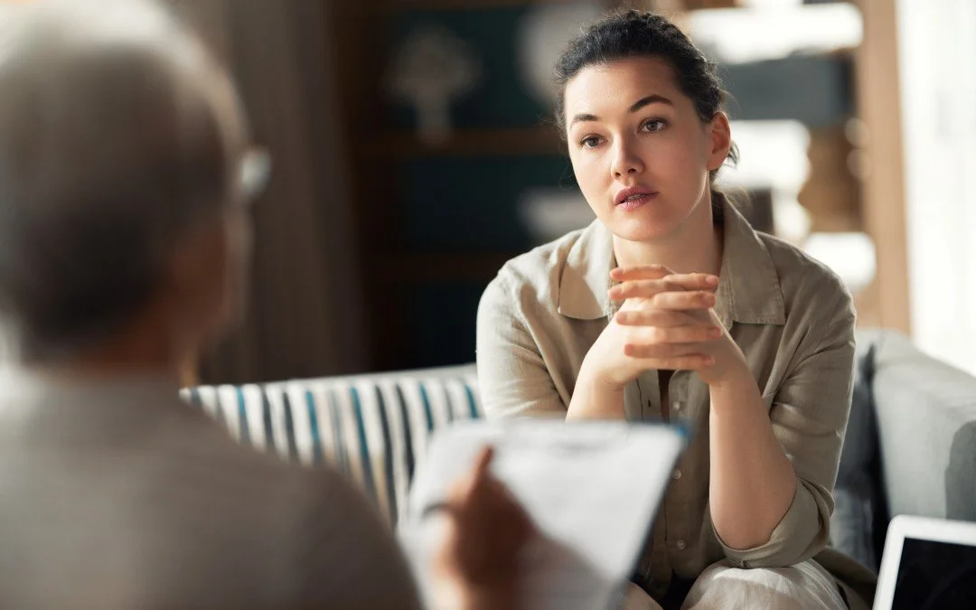 Young woman listening attentively to a specialist during a clinical ADHD assessment