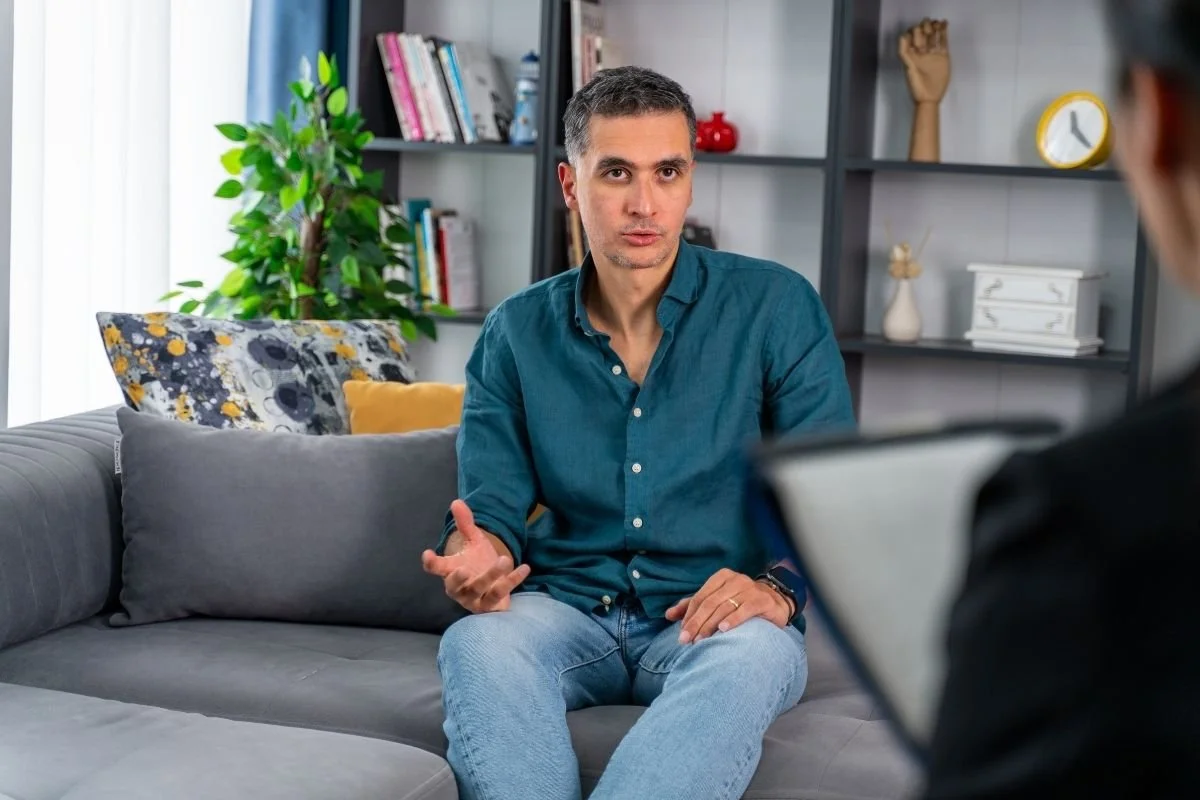 Professional psychotherapy session taking place inside a comfortable psychologist's office.