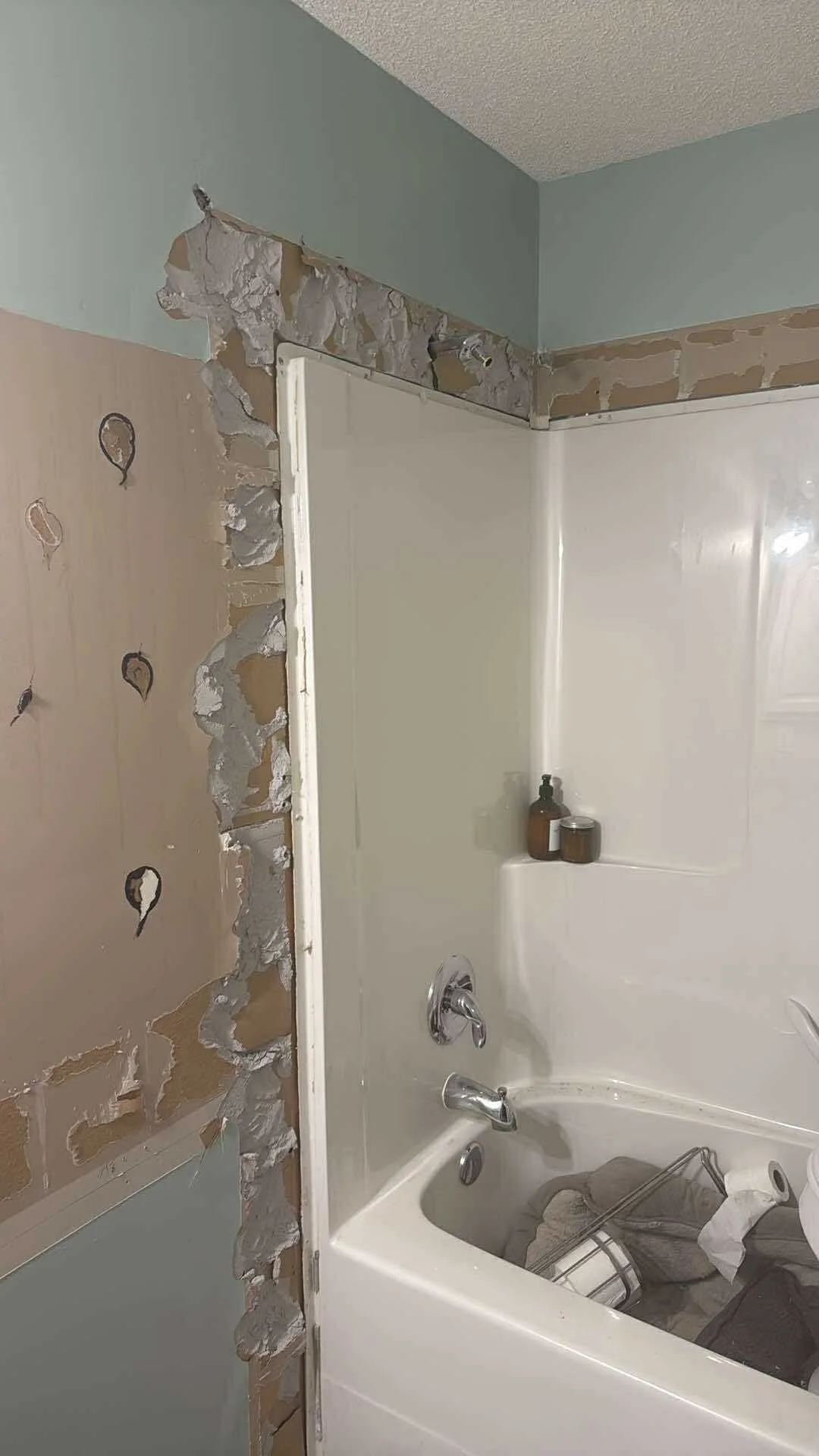 Bathroom Drywall Repair Before: The walls started out with damage, patches, and uneven surfaces, but after careful drywall repair and finishing, the space looks completely refreshed.