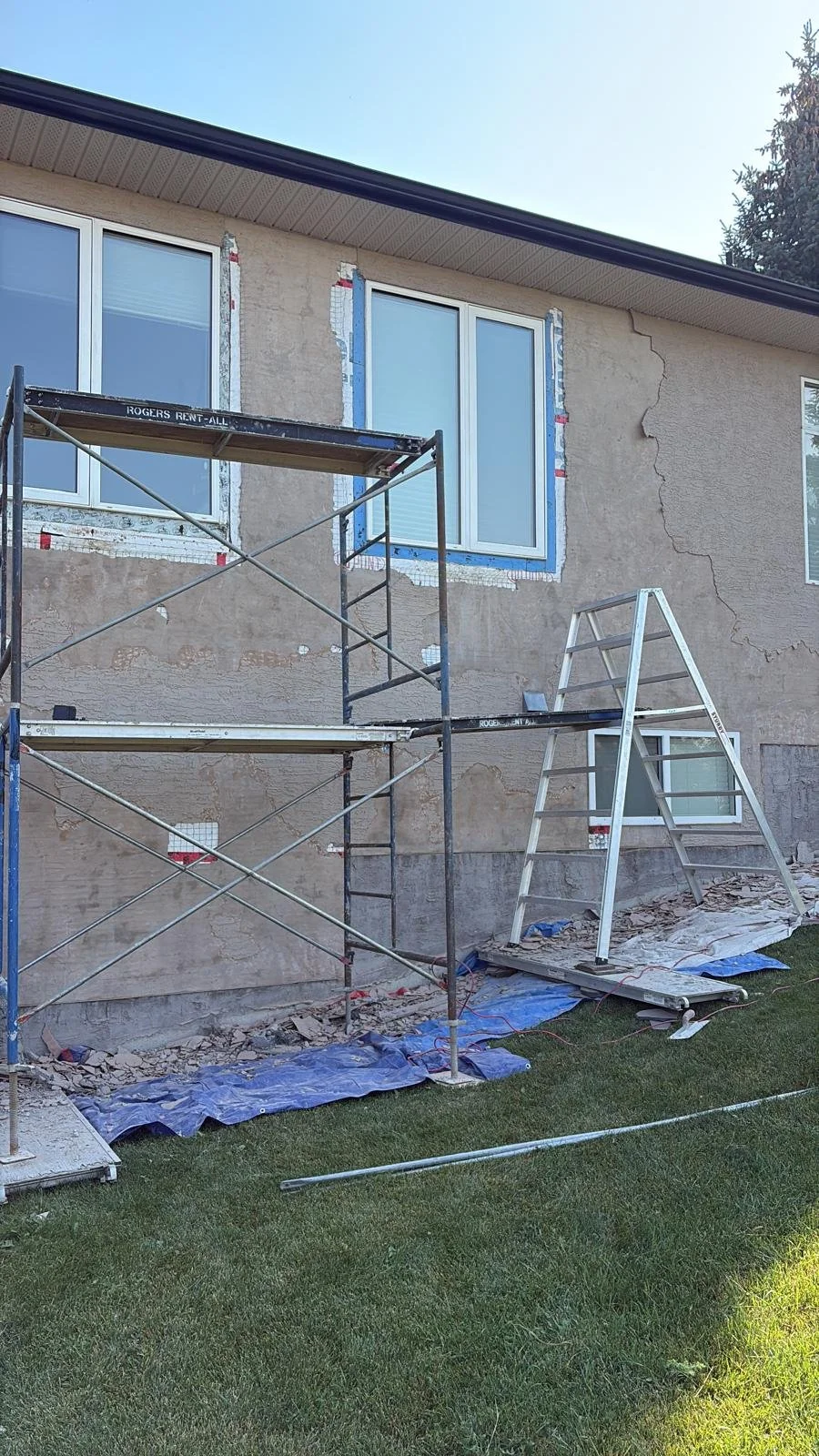 Before: Stucco removed around windows for proper installation and repair