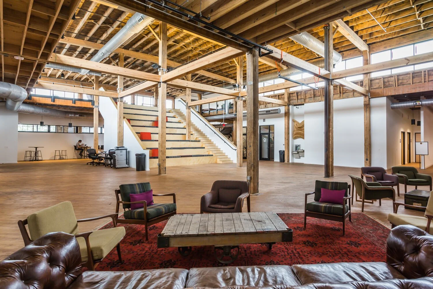idea foundry interior photograpoh showing large wooden beams, spacious interior, and a welcoming lounge area