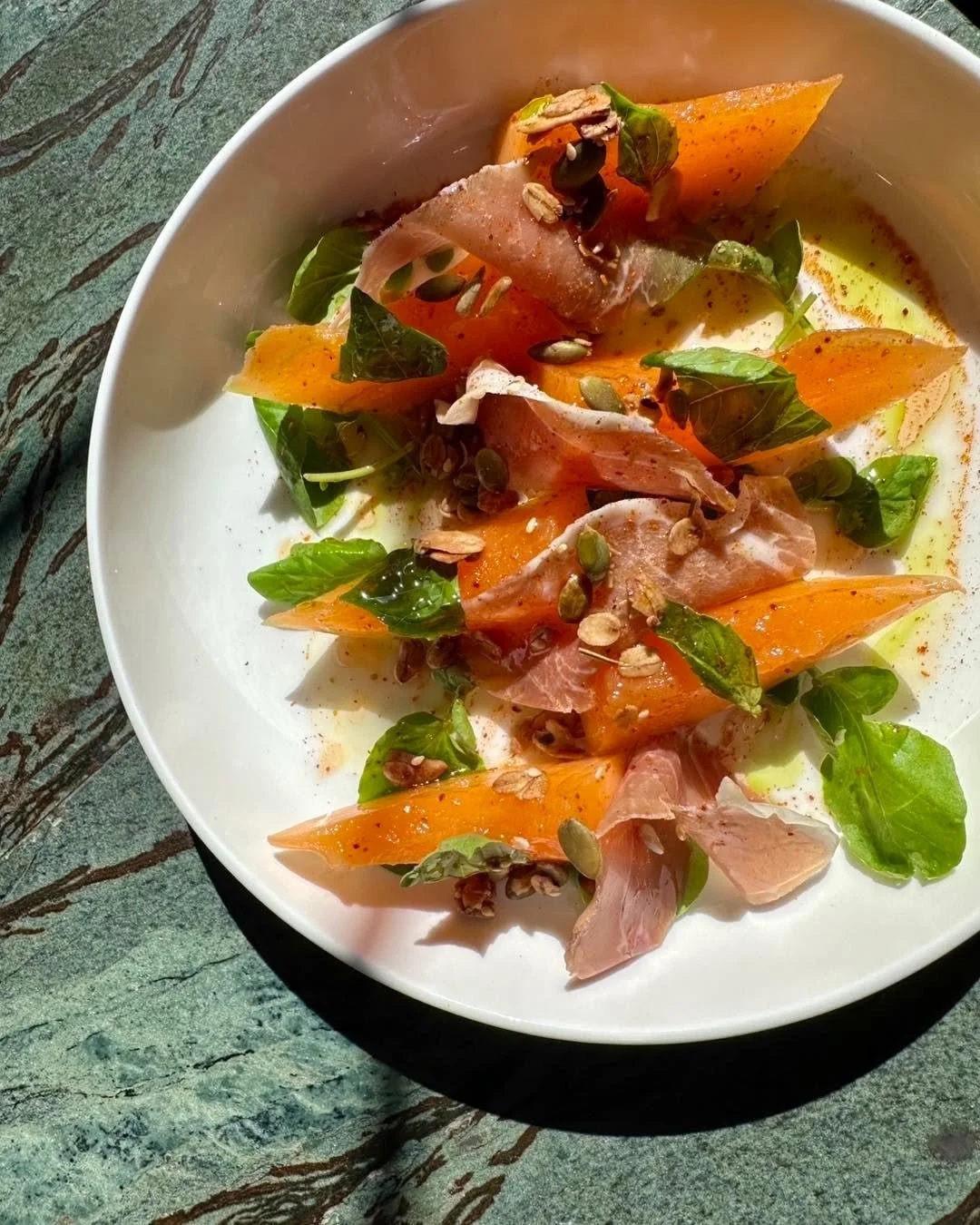 Peak season in the Midwest, rooted in French tradition. We start with sugarcube melons from @mickklugfarms, compressed to concentrate their natural sweetness and texture. Paired with delicate Jambon de Bayonne and finished with local honey, Espelette