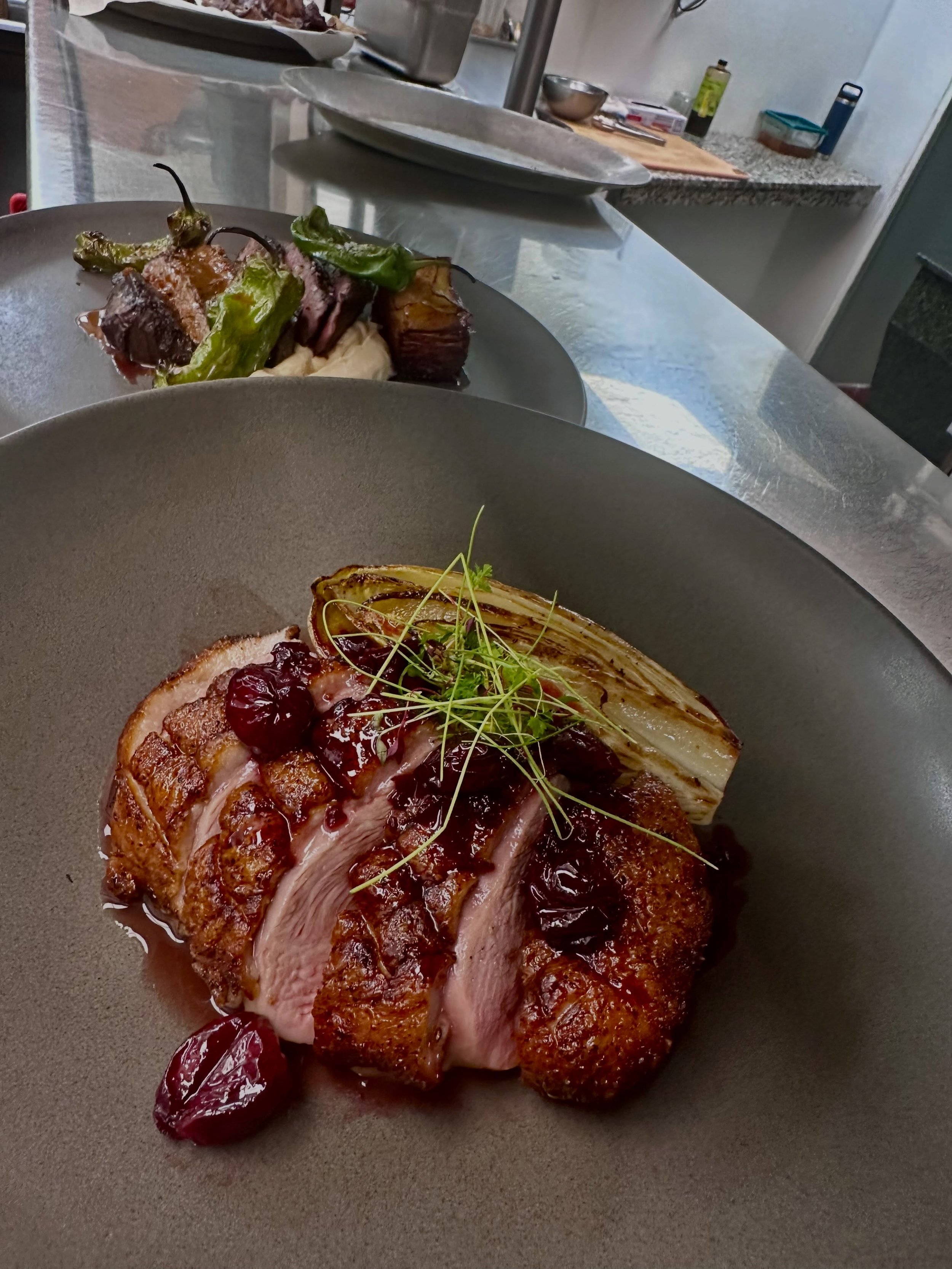 Scenes from the pass this weekend: Our Pekin Duck breast with braised endive, local polenta, and cherry port sauce alongside our Wagyu Flat Iron with caramelized cauliflower puree, blistered shishitos, potato pave, and au Poivre sauce. 

The devil is