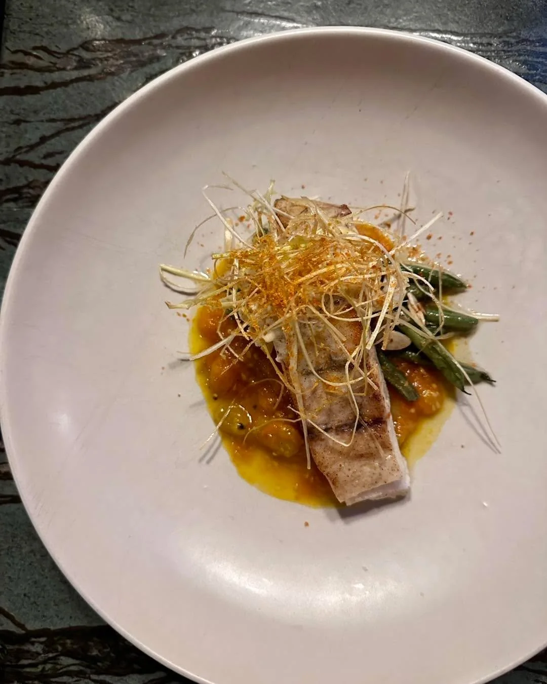 Pan-seared Barramundi @infinitybluebarramundi 

@mickklugfarms sungold tomatoes, almondine green beans, sweet corn compound butter, frizzled leeks, zero-waste tomato powder.

Letting the end of summer Midwestern harvest do the talking. The Sungolds a