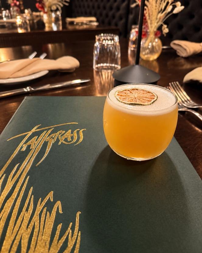 Meet Passion After Dark, your next favorite cocktail at Tallgrass.

A sultry blend of rum, Chinola passion fruit liqueur, fresh lime, Amaro Montenegro, and a touch of cinnamon. Bright passion fruit and citrus meet warm, bittersweet spice for a cockta