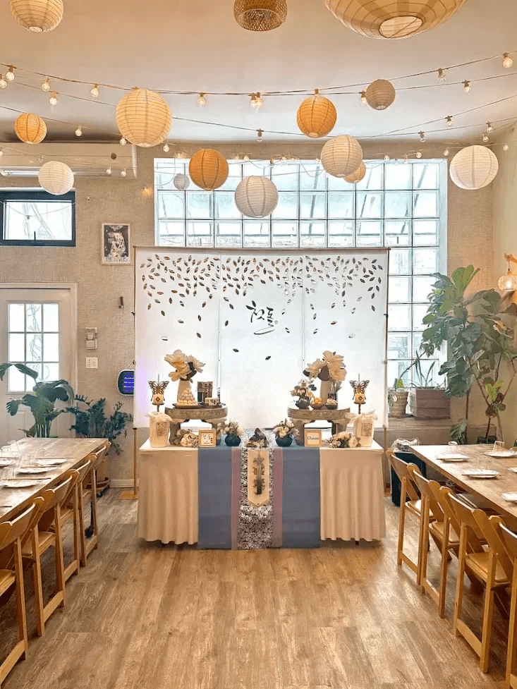 Traditional celebration setup at Bat Haus Brooklyn with decorated dessert table, backdrop, and long table seating for cultural ceremony and private event