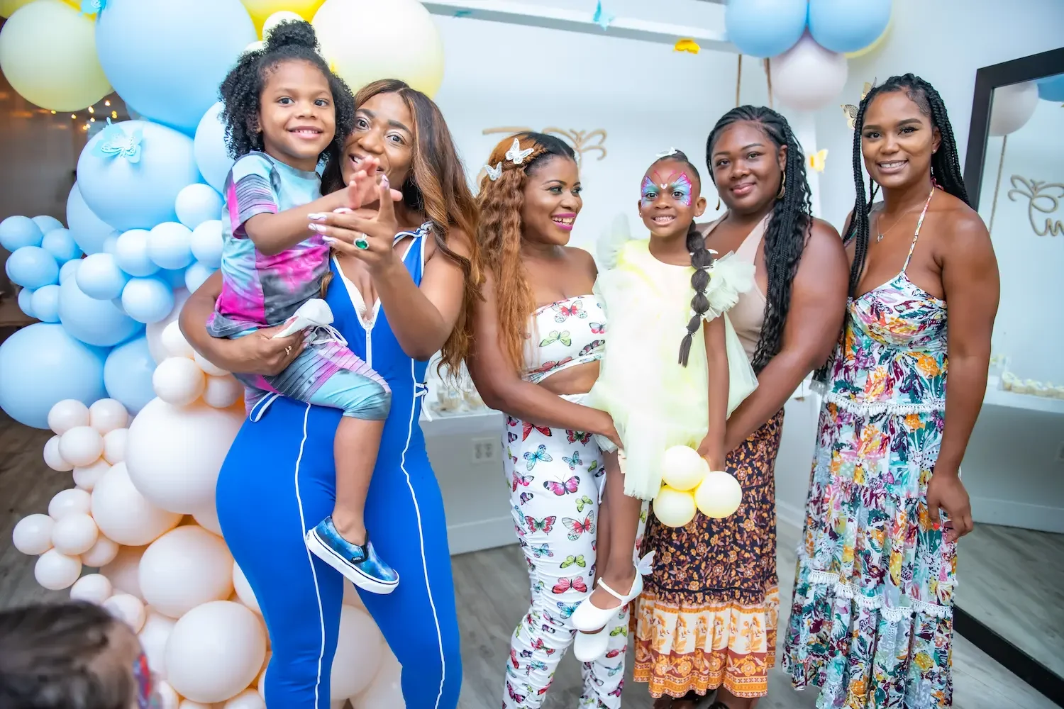 Kids birthday party space in Brooklyn with families and children posing together near balloon decorations during a birthday celebration at Bat Haus.