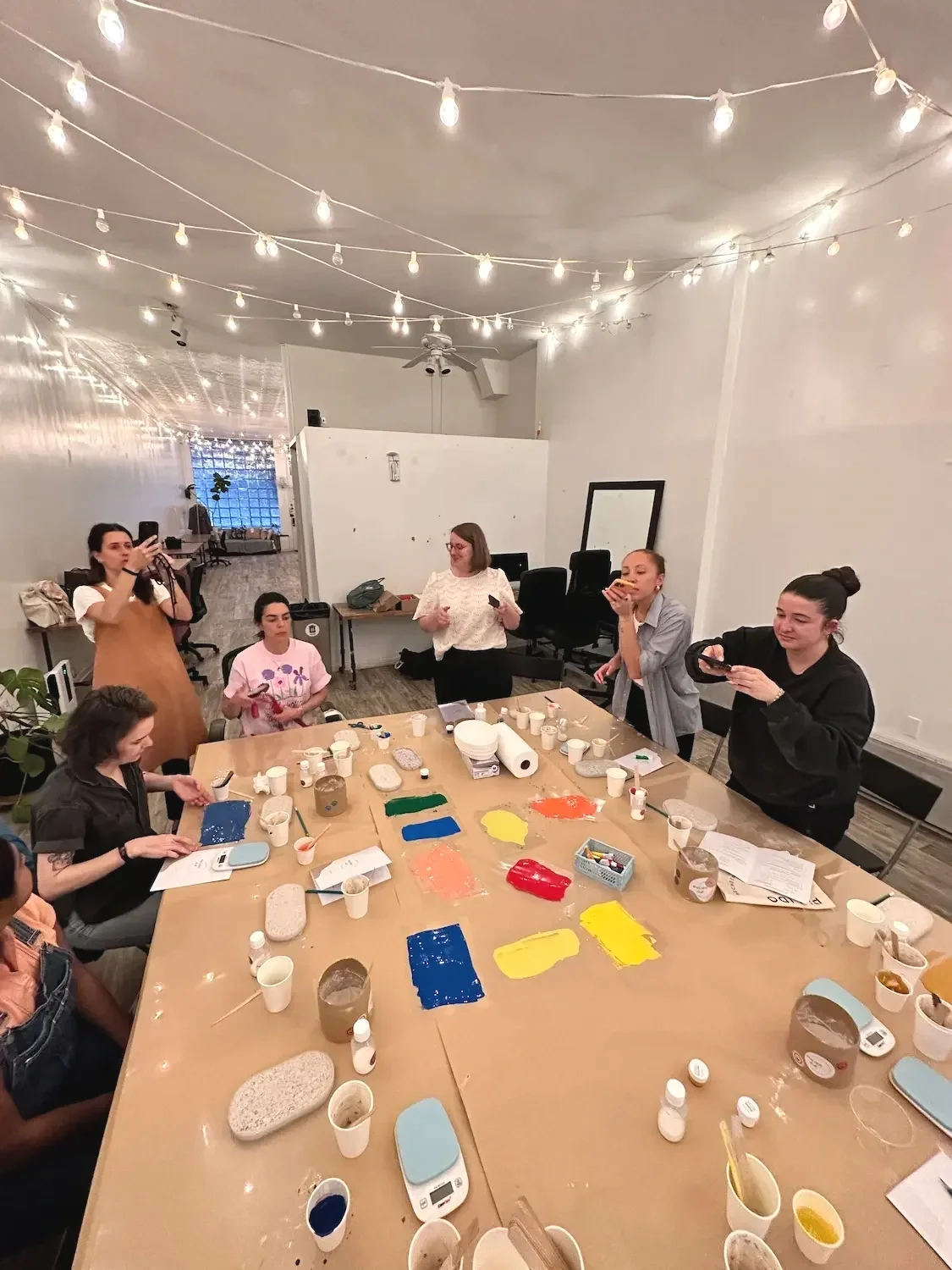 A group taking part in a hands-on craft workshop around the table at a weekday rental at Bat Haus in Brooklyn.