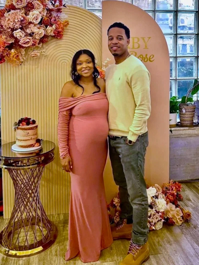 Expecting couple at a baby shower at Bat Haus Brooklyn, with a peach arch backdrop, autumn florals and a naked cake.