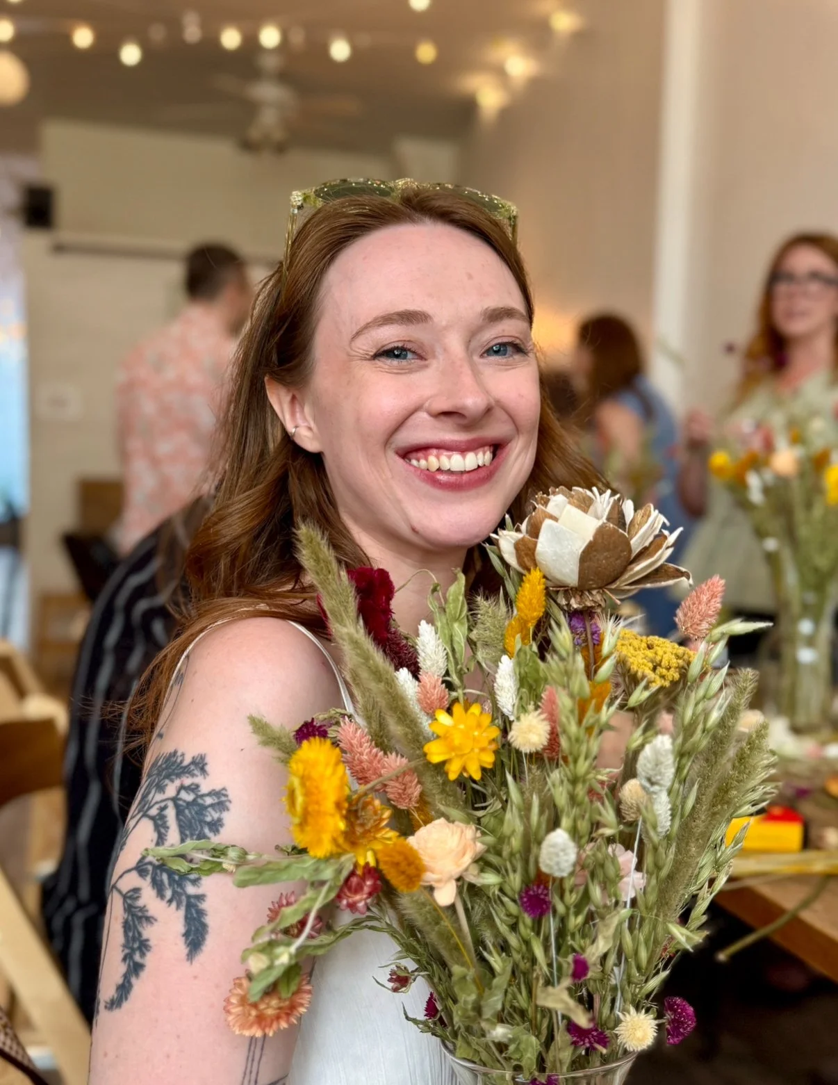Smiling Veronica at the Floral Workshop Holding a Colorful Bouquet