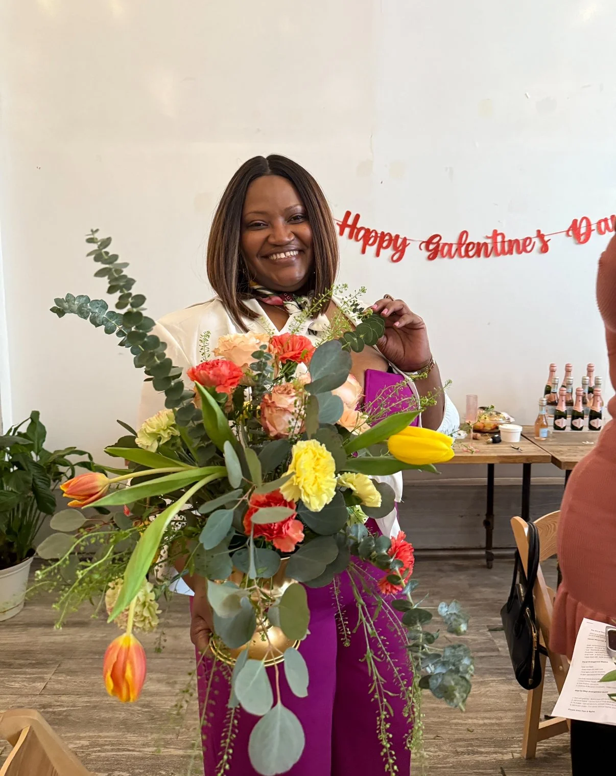  Guest with Bright Floral Arrangement at Birthday Celebration