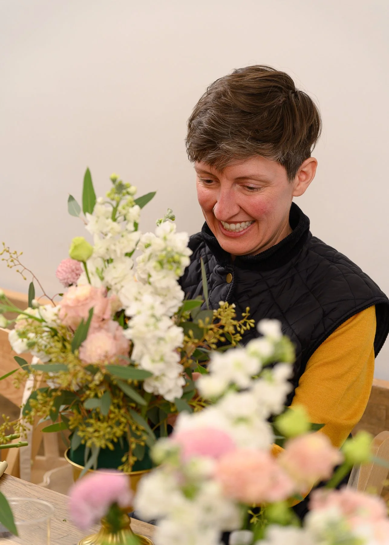 Joyful Guest Holding Freshly Arranged Florals at Client Appreciation Event