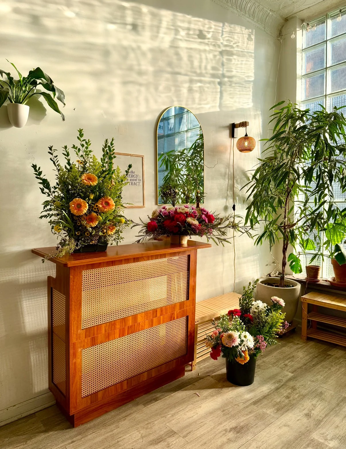 Floral arrangements displayed inside Bat Haus in Williamsburg Brooklyn, featuring seasonal flowers, greenery, and warm natural light in a private event venue setting.