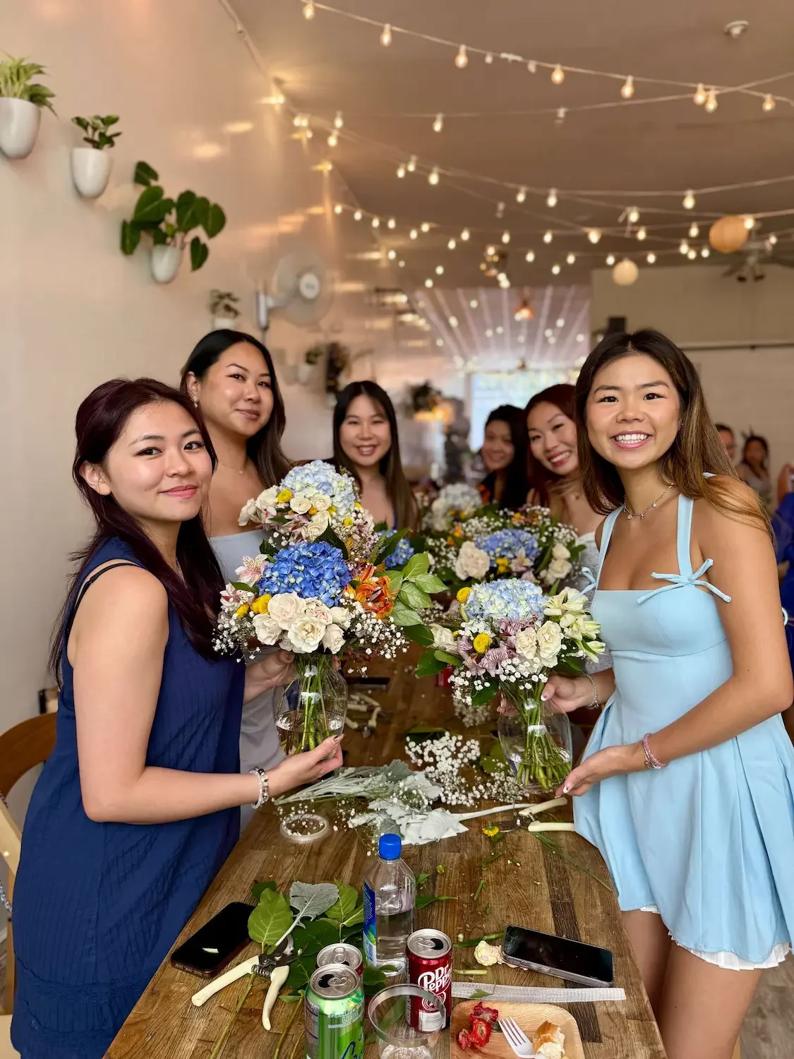Bridal party holding handmade bouquets at a bridal floral workshop at Bat Haus in Williamsburg, Brooklyn.