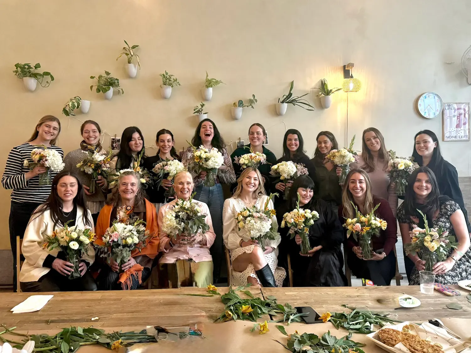 bridal shower floral workshop brooklyn at bat haus, group of guests holding fresh flower arrangements during a private floral design class celebration