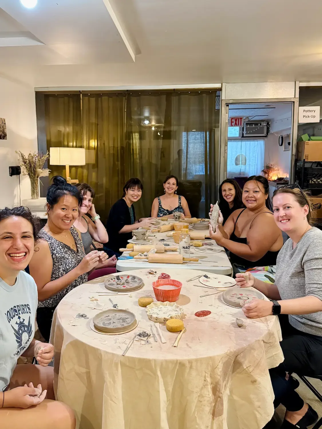 downstairs studio at bat haus brooklyn for small gatherings, guests participating in a private pottery hand building class around a table in an intimate workshop space for up to 15 people