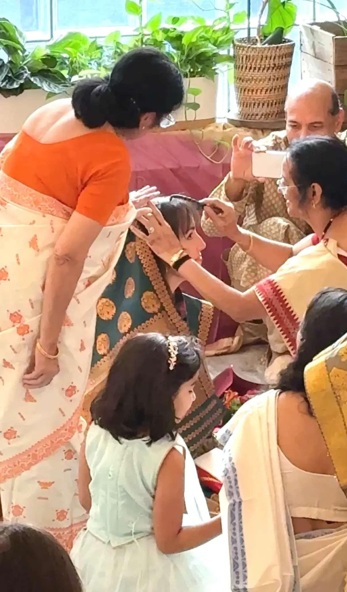 Family members blessing the bride during a traditional Indian Joron ceremony at Bat Haus in Williamsburg, Brooklyn.