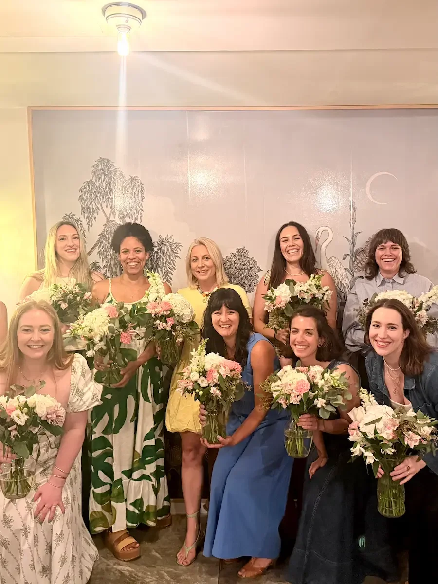A birthday group holding handmade bouquets after a floral arranging workshop at Bat Haus in Williamsburg, Brooklyn.