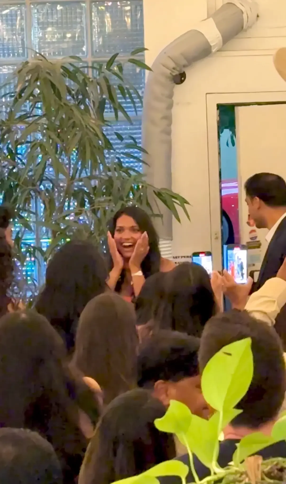 Guests applauding the bride-to-be during a surprise proposal party at Bat Haus, a private engagement venue in Williamsburg, Brooklyn.