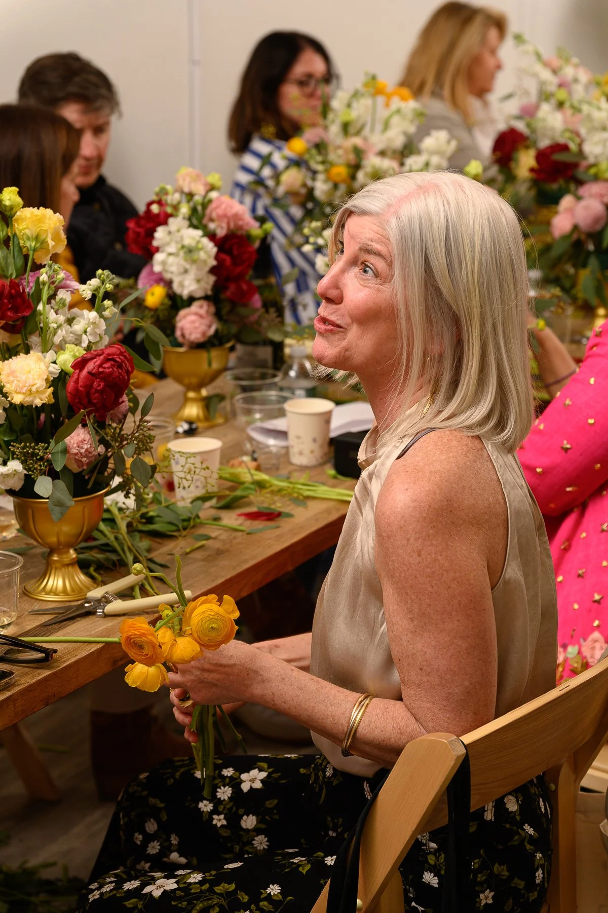 A guest arranging her own bouquet at a bridal floral arranging workshop at Bat Haus in Williamsburg, Brooklyn.