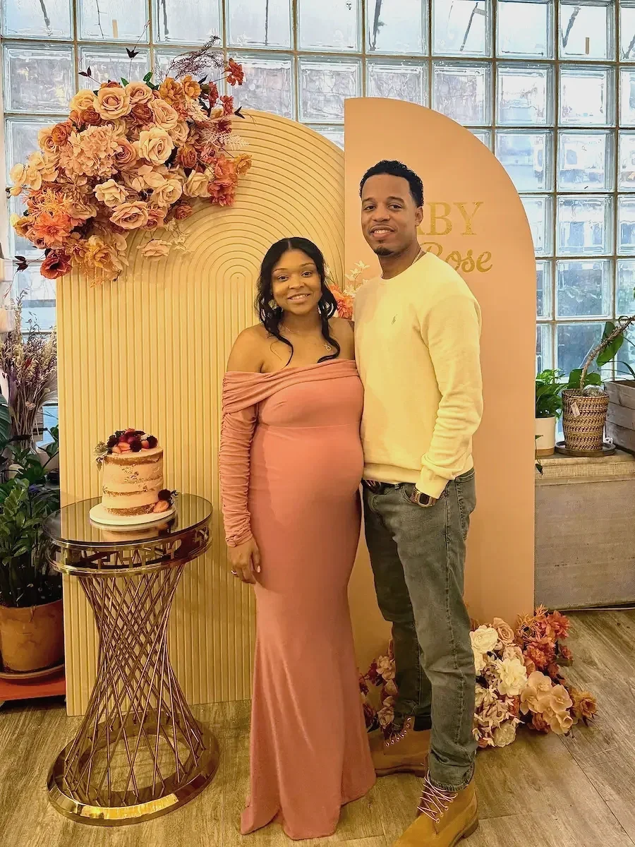 Beautiful baby shower decor backdrop at bat haus brooklyn with smiling couple in the front