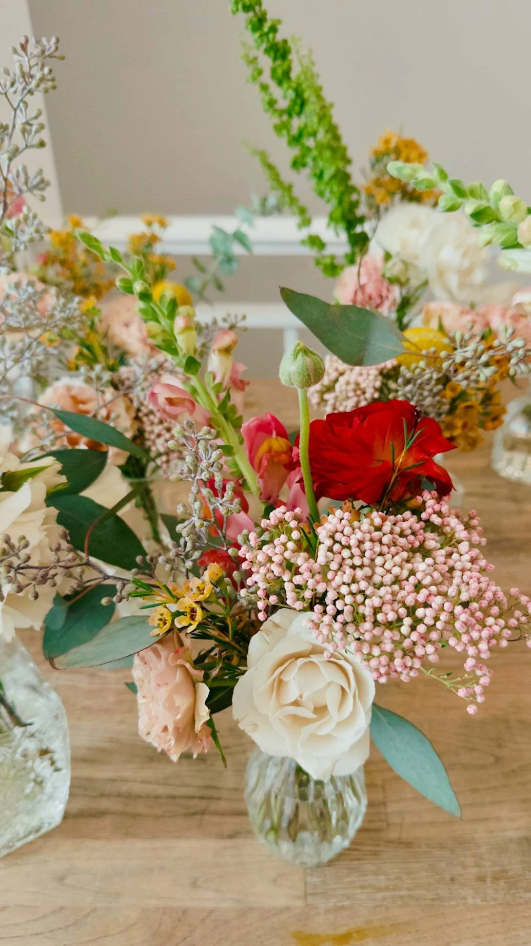 Close-up of seasonal bud vase florals included in the Bat Haus Styled Package, featuring soft pastel blooms, greenery, and natural textures for intimate events in Brooklyn.