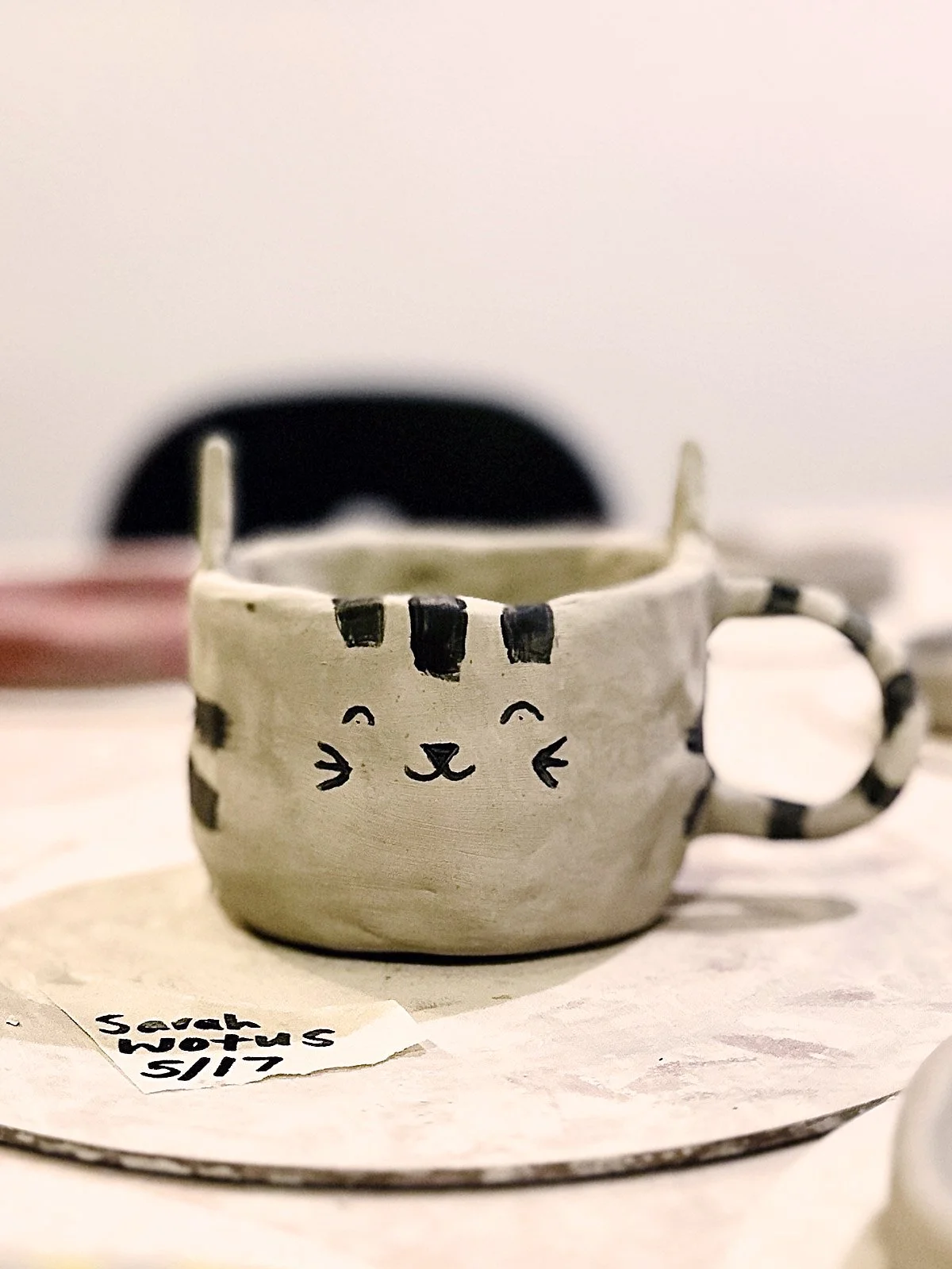 A handmade ceramic cat mug created at a pottery class at Bat Haus in Williamsburg, Brooklyn.