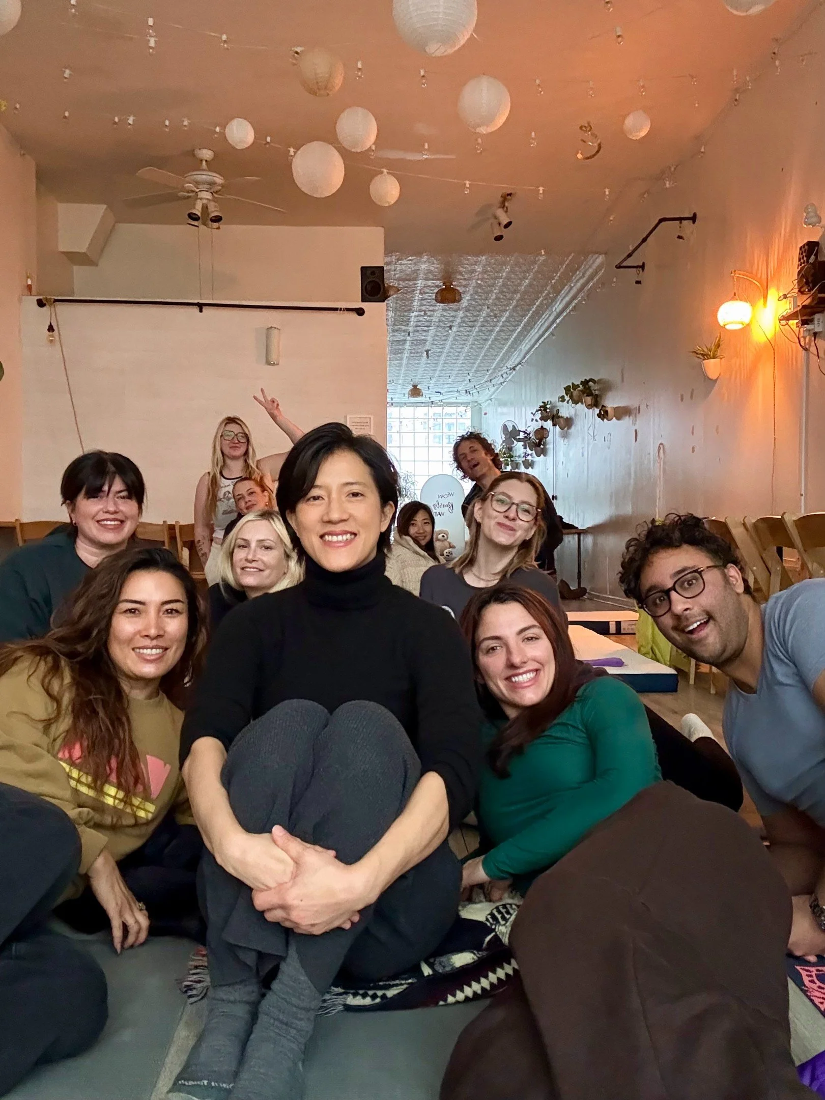 Group gathered for a private birthday sound bath at Bat Haus in Brooklyn, sharing a relaxed, joyful moment of connection and presence led by Soundawn.