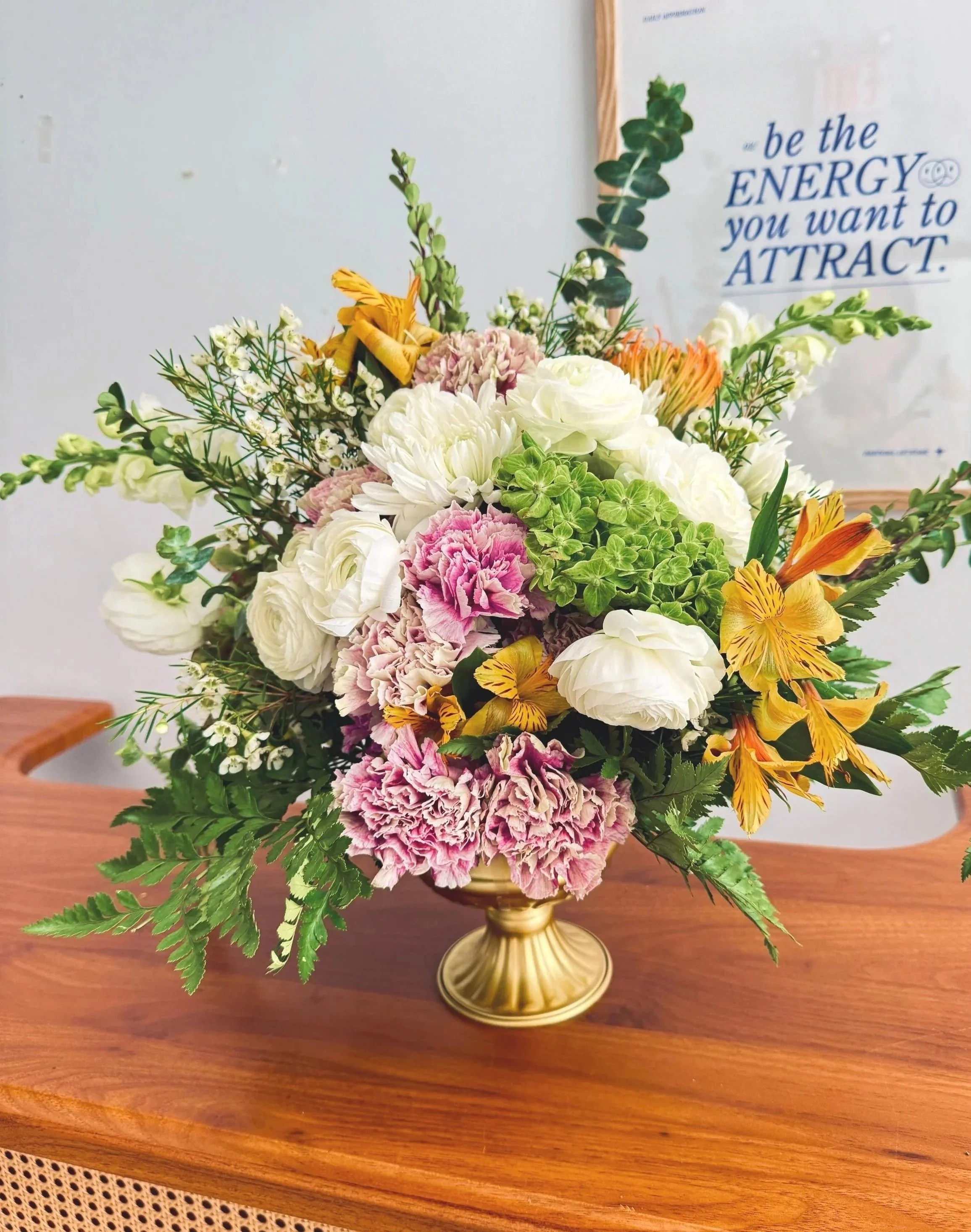 Signature entryway floral arrangement at Bat Haus featuring abundant seasonal blooms in a statement pedestal vase, designed to welcome guests into a Brooklyn wedding or private event.