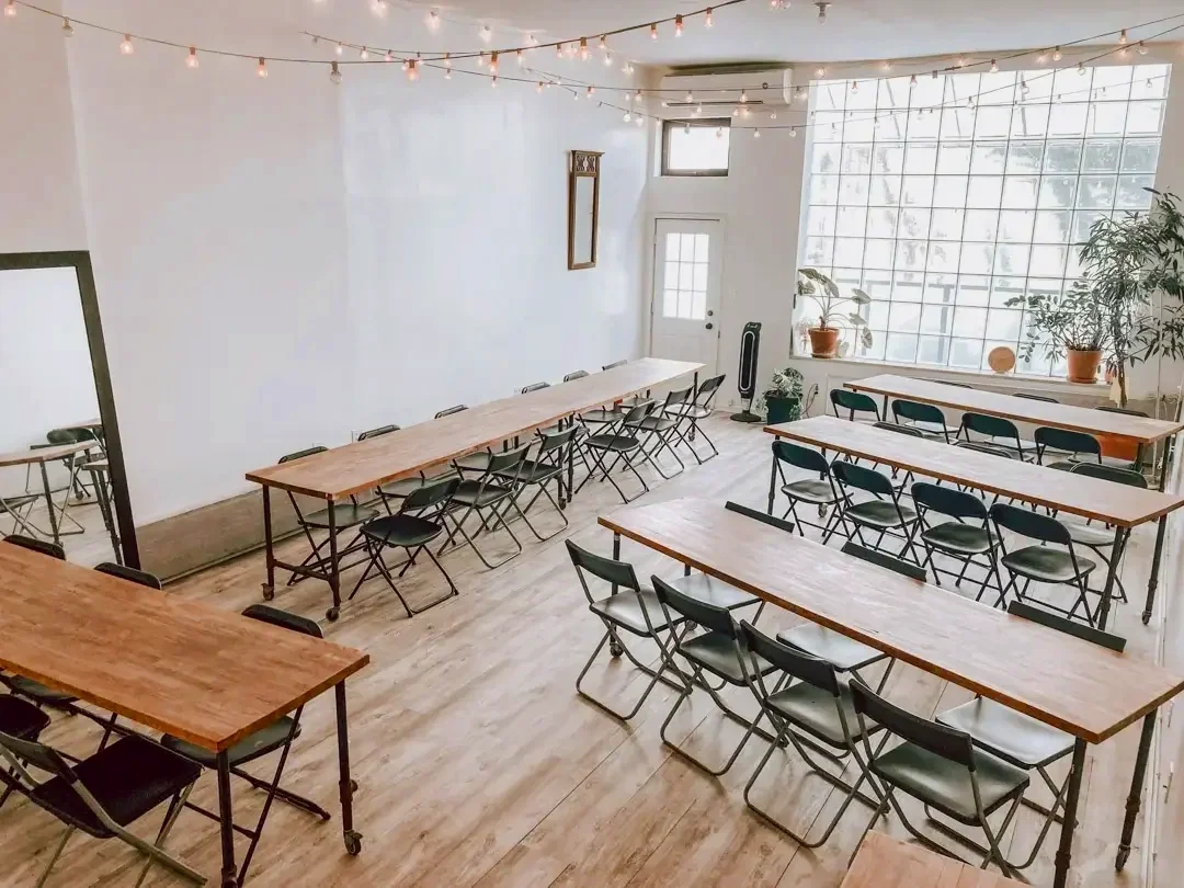 Classroom style table and chair configuration at Bat Haus in Brooklyn showing flexible layout for corporate offsite meetings and presentations.