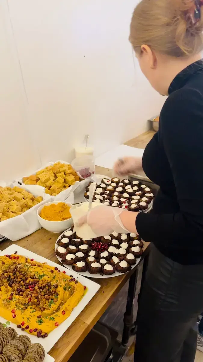 Dessert table at Bat Haus Brooklyn event space featuring plated sweets, mini cupcakes, and catered desserts being arranged for a private celebration.