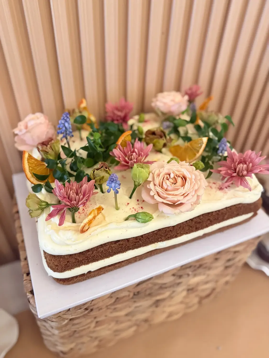 A floral-topped engagement party cake at Bat Haus, a BYO event space in Williamsburg, Brooklyn.
