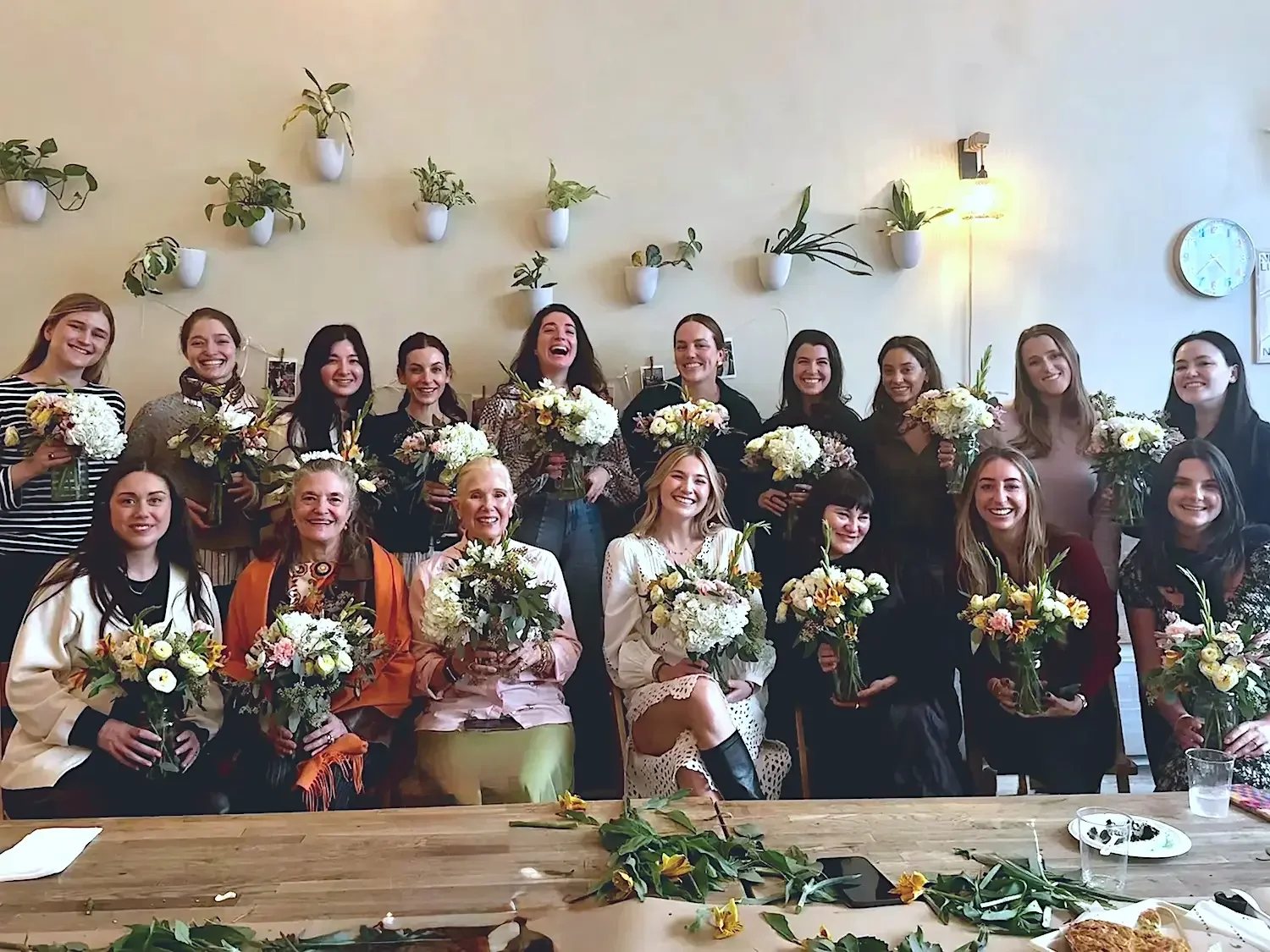 A bridal shower group holding handmade bouquets after a floral arranging workshop at Bat Haus in Williamsburg, Brooklyn.