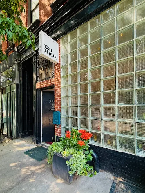 Exterior of Bat Haus, a Brooklyn event space in Williamsburg, featuring the glass block window facade and street entrance.