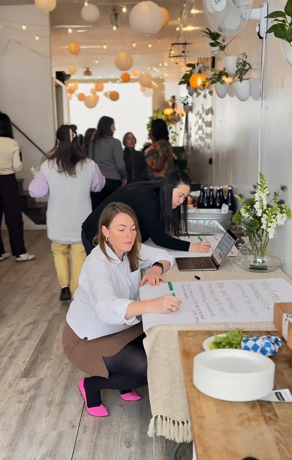 Colleagues mapping ideas on large paper during a strategy session at a corporate offsite at Bat Haus in Brooklyn.