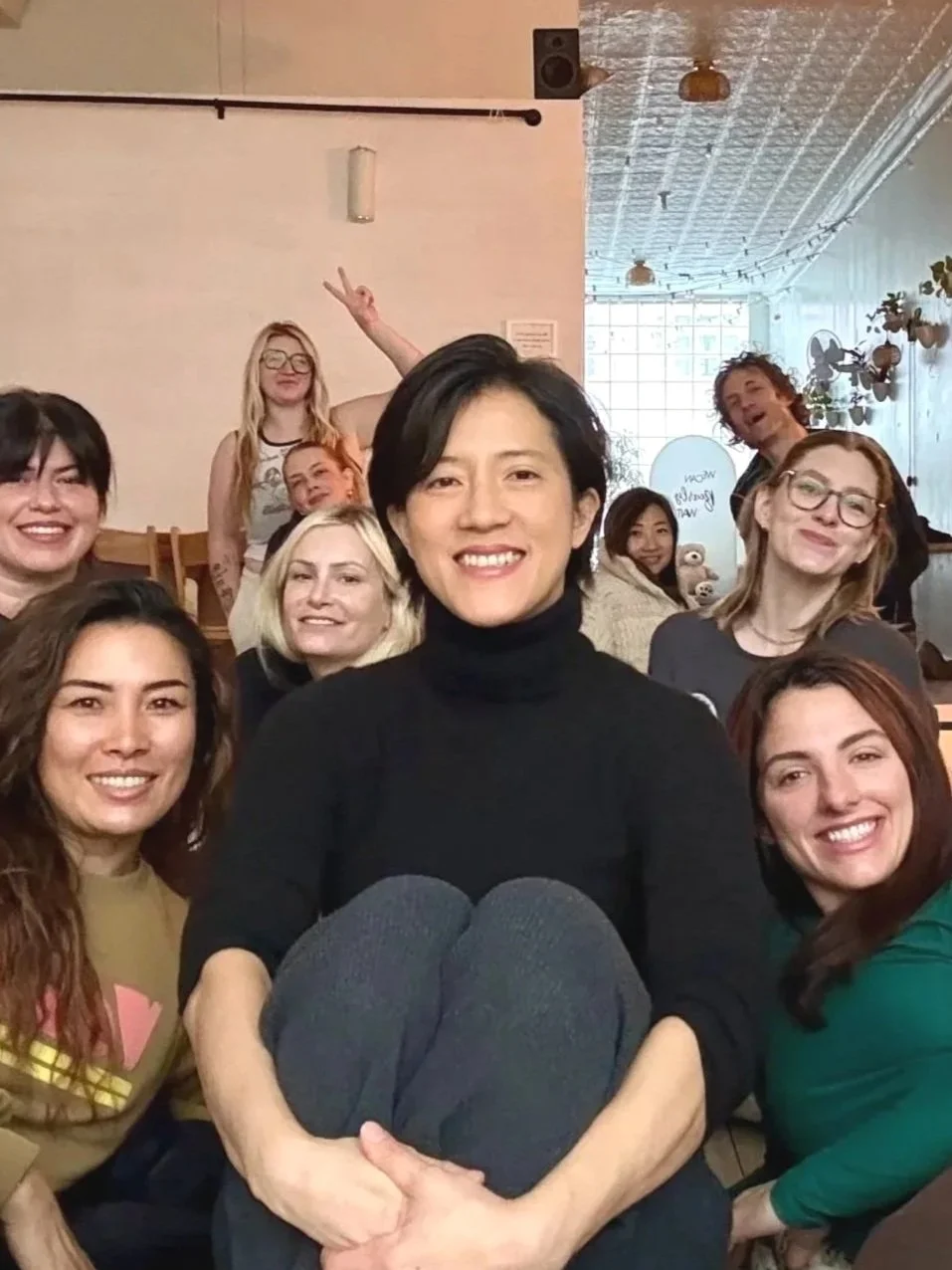 Bat Haus founder Natalie Chan seated with her sound bath participants during a community wellness session at her Brooklyn studio.
