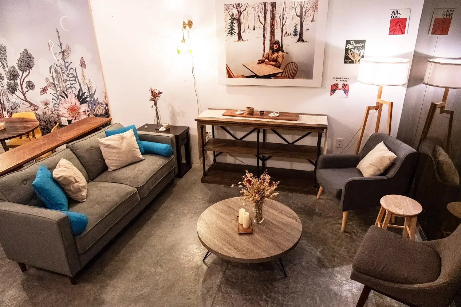 Cozy downstairs lounge with a sofa, armchairs, and coffee table at Bat Haus event space in Williamsburg, Brooklyn.