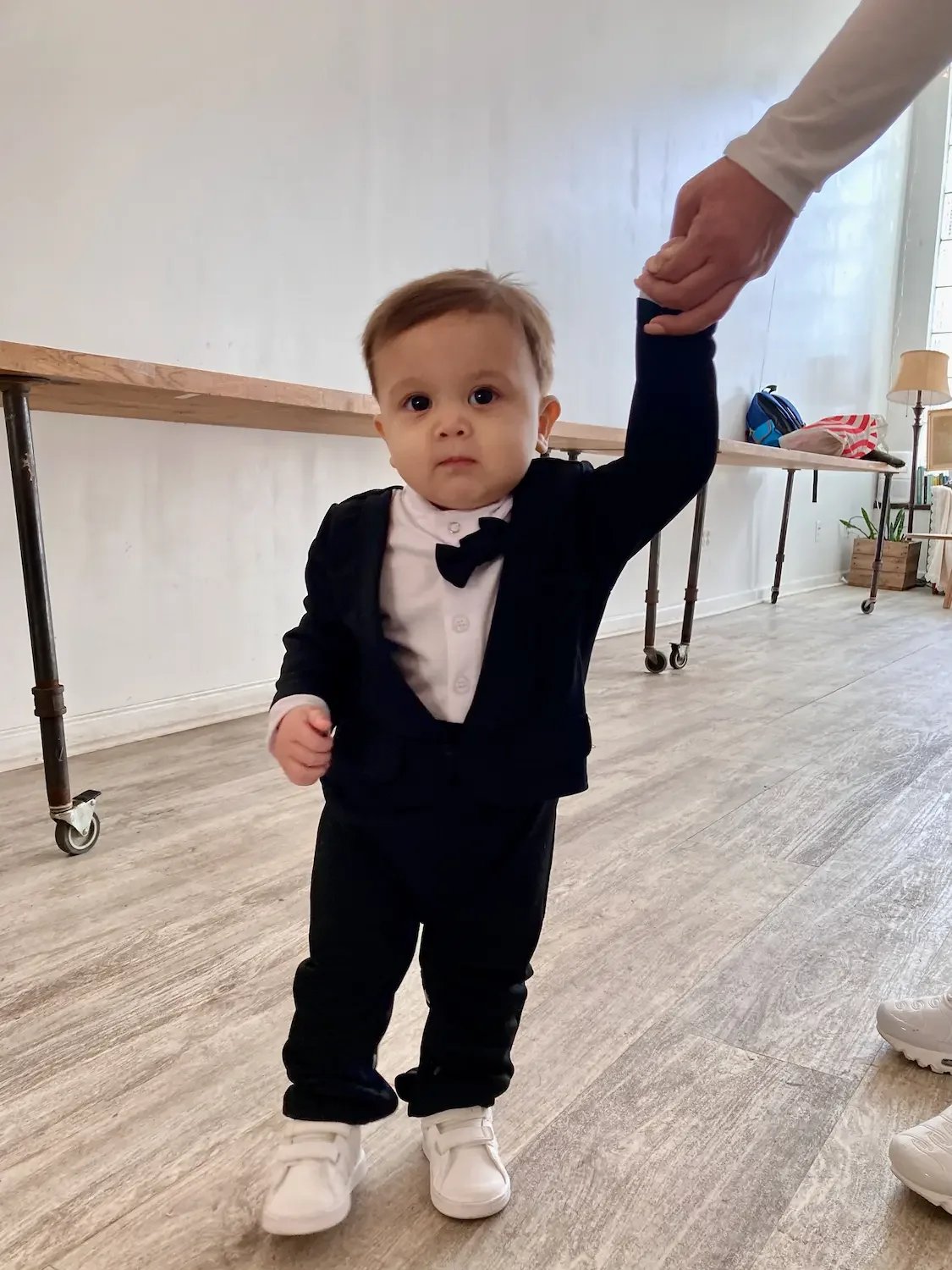 A toddler in a tuxedo at a first-birthday party at Bat Haus, a kids' party venue in Williamsburg, Brooklyn.