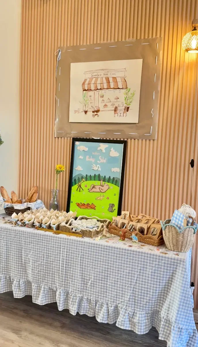 Baby shower dessert and food table with a custom sign at Bat Haus, a baby shower venue in Williamsburg, Brooklyn.